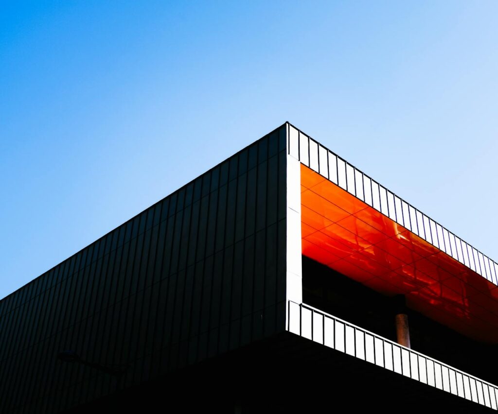 Orange and Black Concrete Building Under Blue Sky